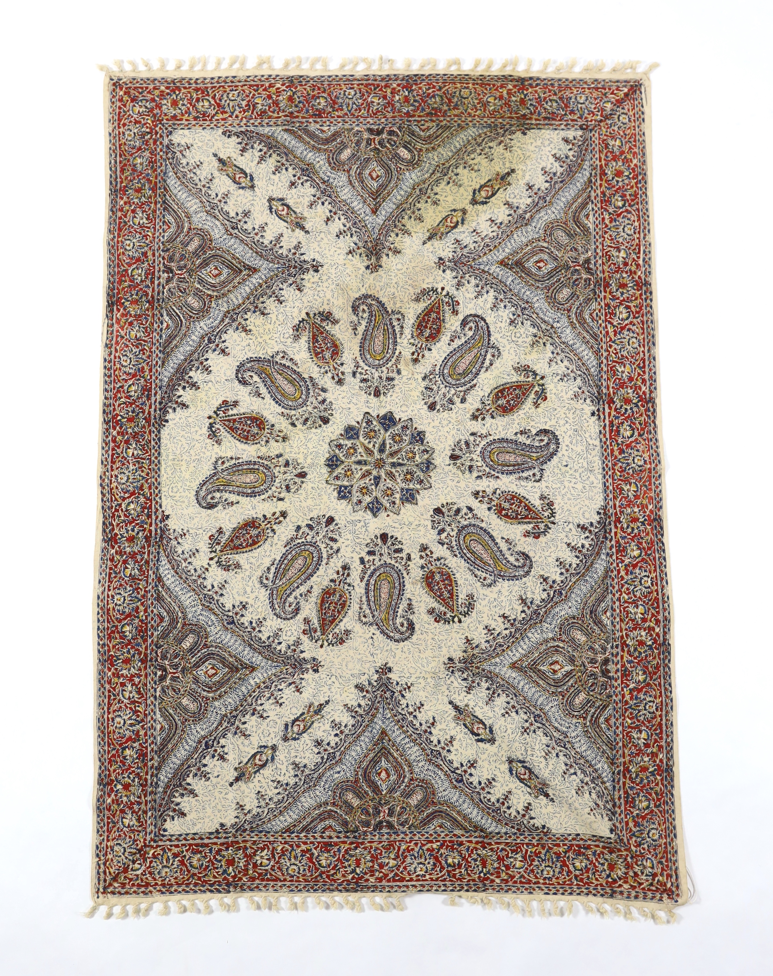 A 20th century Iranian printed paisley shawl, designed using indigo, red and ochre dyes, finished with knotted tassels either end, with an ink maker’s stamp on reverse, 148cm long x 100cm wide